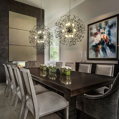 a dining room table with chairs and chandelier