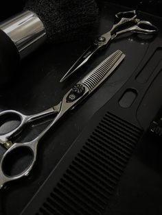 a pair of scissors sitting on top of a table next to a hair dryer