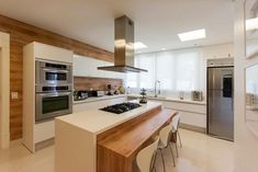 a modern kitchen with an island and stainless steel appliances