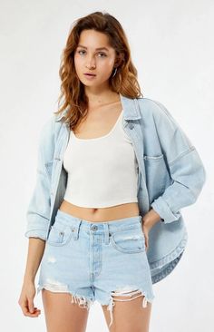 These 501 Light Blue Frayed Denim Shorts from Levi's are the perfect Instagram-worthy piece to complete your summer look. The classic blue wash and high-rise fit flatters any body type while the frayed hem adds laidback style. Whether you're hitting the beach or brunch with friends, these shorts will photograph beautifully from any angle and flatter your social posts. Made with vintage details like rolling stitching and distressing, these shorts transport you to easy, effortless summers past and become your go-to casual piece all season long.