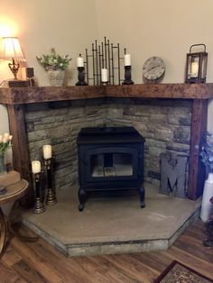 a living room with a fire place in the corner and candles on the fireplace mantel