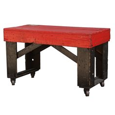 a red bench sitting on top of a wooden table