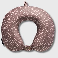 a pink and white polka dot print neck pillow