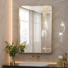 a bathroom with a sink, mirror and vase on the counter top in front of it