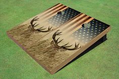 the american flag and deer antlers are depicted on this cornhole board game set