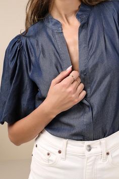 Bring a chic vibe to your everyday looks with the Lulus Contemporary Crush Dark Blue Chambray Puff Sleeve Button-Up Top! Lightweight woven chambray fabric shapes this stylish top that has pleated-like detailing at the shoulders and short puff sleeves with elastic at the cuffs. Crew neckline tops a functional, hidden button placket that runs down the bodice to rounded hems. Fit: This garment fits true to size. Length: Size medium measures 25" from shoulder to hem. Bust: Great for any cup size. Wa Denim Blue Button-up Workwear Blouse, Trendy Button-up Denim Blouse, Chic Denim Button-up Top, Trendy Denim Button-up Blouse, Chic Short Sleeve Denim Top For Day Out, Chic Puff Sleeve Shirt For Work, Chic Short Sleeve Denim Blue Top, Chic Denim Blue Short Sleeve Top, Trendy Blouse With Puff Sleeves And Button Closure