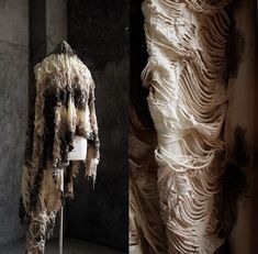 two photographs of clothes on display in a room with stone walls and curtains behind them