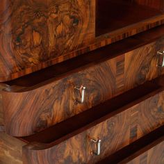 the drawers are made from wood and have handles on each drawer, which is also inlaid with metal hardware