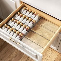 an open drawer with many bottles in it