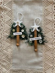 two wooden pegs are decorated with christmas decorations