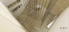 the interior of a building with wood floors and metal bars on the wall, looking down