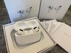 an open box with two airpods in it