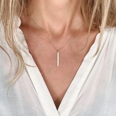 "Sleek and simple, our dainty minimalist bar hangs vertically on a dainty chain. Available in 14k gold filled, sterling silver and rose gold filled. Model is shown wearing a 17\" bar necklace in gold filled. CRAFTSMANSHIP  Jewelry is handmade by us in our NYC studio. We focus on craftsmanship and quality using only the highest quality materials and handpicked genuine gemstones.  PACKAGING We take pride in creating beautifully packaged orders. Jewelry arrives delicately wrapped in tissue and placed in a kraft box inside a logo drawstring pouch. Your package will arrive nice enough to gift someone.  If you need your order by a certain date, it is very important to send us a message on Etsy directly after you place your order, as well as write it in the 'Notes to Seller' at checkout.  FREQUEN Style Aesthetics, Necklace Bar, Minimalist Bar, Vertical Bar Necklace, Nyc Studio, Vertical Bar, Hanging Bar, Gold Bar Necklace, Dainty Chain