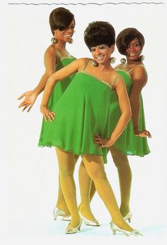 three women in green dresses posing for the camera