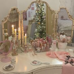 a dressing table with a christmas tree in the corner and many other items on it