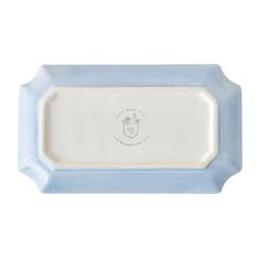 a blue and white tray with a baby's face on the bottom, in front of a white background