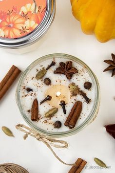 an assortment of spices on a table next to a jar of cinnamons and star anise