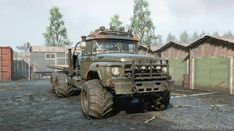 an old army truck parked in front of a building on the side of a dirt road