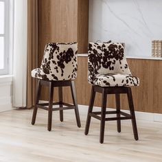 two brown and white chairs sitting next to each other