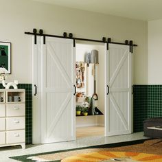 the interior of a room with green tile walls and white sliding doors that open up