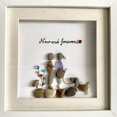 some rocks and flowers in a white frame with the words now and forever written on it