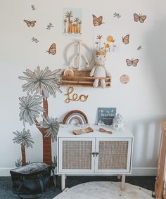 a child's room decorated in white and gold with lots of butterflies on the wall