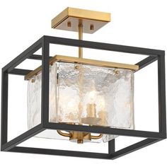 a square light fixture with clear glass in an open box style frame and gold accents