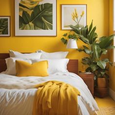 a bedroom with yellow walls, white bedding and pictures on the wall above it