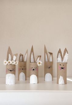 several toilet paper rolls with bunny ears and flowers on them are lined up in a row