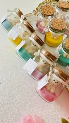 small glass jars filled with different types of candies