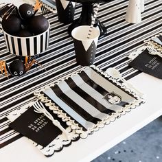 a table topped with black and white striped paper