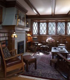 a living room filled with lots of furniture and a fire place next to a window