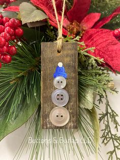 a christmas ornament hanging from a pine tree