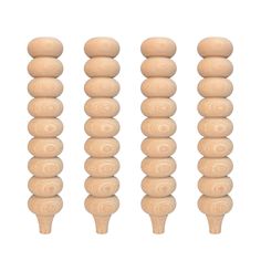 four wooden dowels are shown in three different sizes and shapes, each with an individual's head