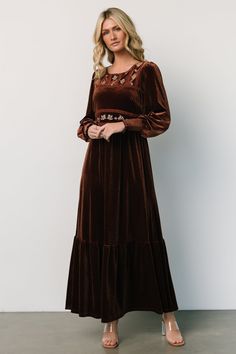 The chocolate velvet maxi dress with waist and chest flower details is a luxurious and enchanting choice for special occasions. Its rich chocolate color, combined with the intricate flower embellishments on the waist and chest, creates a captivating and elegant look that is sure to make a statement. Brown Maxi Dress For Fall Evening, Brown Maxi Dress For Evening In Fall, Brown Fall Evening Maxi Dress, Brown Fitted Maxi Length Dress, Modest Brown Maxi Dress, Modest Brown Long Sleeve Maxi Dress, Modest Long Sleeve Brown Maxi Dress, Fitted Brown Floor-length Maxi Dress, Modest Fitted Brown Maxi Dress