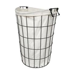 a black and white wire basket with a canvas liner on the bottom is shown in front of a white background