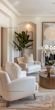 a living room filled with white furniture and flowers