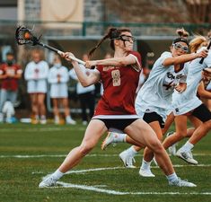 the girls are playing lacrosse on the field