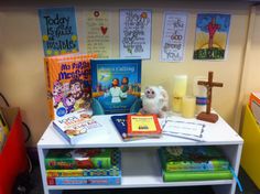 a white table topped with books and a stuffed animal on top of it's shelf