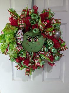 a christmas wreath with a grin face on it