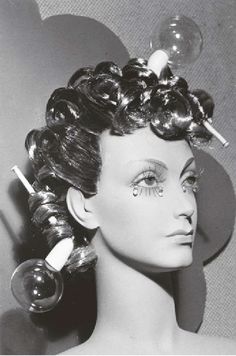 a mannequin with fake hair and makeup on it's head is shown in black and white