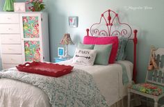 a bedroom with blue walls and white furniture