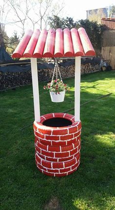 a red brick fire pit sitting on top of a lush green field