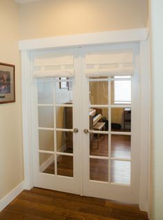 an empty room with two glass doors in it