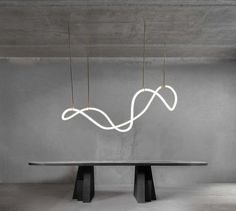 a long table with three lights hanging from it