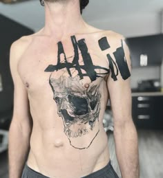 a man with a skull tattoo on his chest