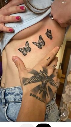 a woman's stomach with butterflies on it and the bottom half of her stomach