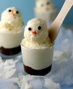 two desserts with marshmallows and chocolate in them on a blue tablecloth