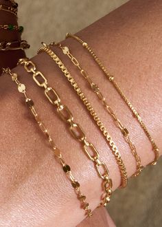 Everyone needs a simple chain that pairs well with every stack, and the Bennett bracelet is our go-to box chain. With a sleek shine that reflects from every angle, this piece is perfect for any minimalist who loves to stack. 14k Gold Fill Length: 6" + 1" ext Make your jewelry last! Click here for jewelry care. Need a gift box? We got you. Sparkle Bracelet, Simple Chain, Sparkle Necklace, Layered Bracelets, Classic Gold, Black Accents, Matching Necklaces, Box Chain, Gold Beads