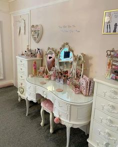 there is a vanity with many drawers and mirrors